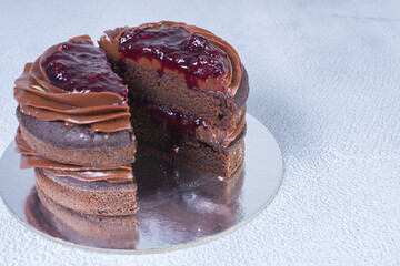 Chocolate cake and blackberry sauce on a gray background