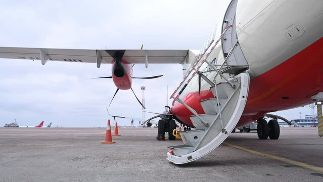 Side view of small private plane that is on the airport outdoors