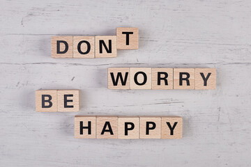 wooden blocks building the word DONT WORRY BE HAPPY