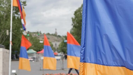 Armenian flags in the wind movement. Lots of Armenian flags on the square. DOF, slow motion