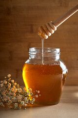 Fresh Honey in glass jar with dipper