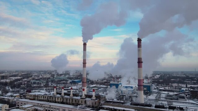 Industrial Factory smokestack emissions from manufacture using natural gas in winter. Global energy crisis after Russia's invasion of Ukraine. Aerial view