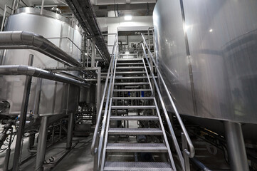 Obraz premium Metal steps near huge tanks for fermented milk products