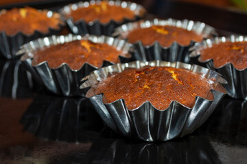 Obraz na płótnie Canvas Baked cupcakes in metal molds in the oven. Selective focus.