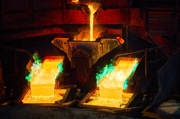 Pouring liquid copper metal for anodes into form in workshop