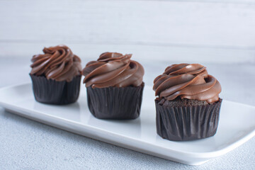 Rum flavored chocolate cupcake displayed on gray background