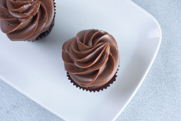 Rum flavored chocolate cupcake displayed on gray background