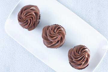 Rum flavored chocolate cupcake displayed on gray background