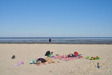 Fototapeta na wymiar blankets, toys etc. are lying on the beach of the North Sea in Schillig, Germany