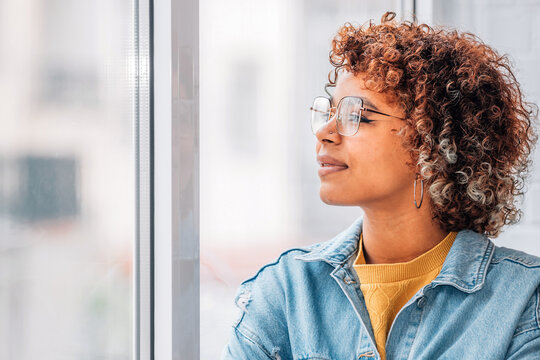 Pensive Girl Or Woman Looking Out The Window