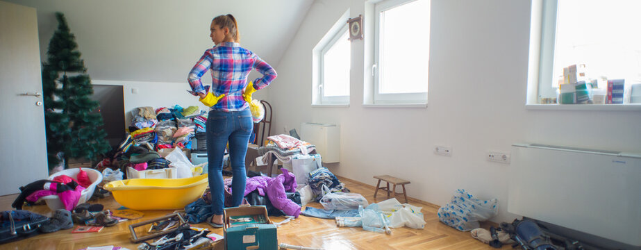 Young angry woman preparing to clean mess in the attic