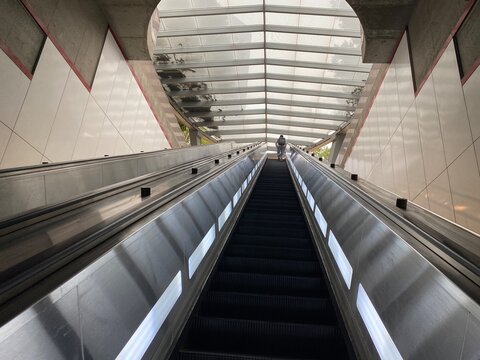 LOS ANGELES, CA, SEP 2021: escalator with person silhouetted at top, leading up from Pershing Square Station on the LA Metro underground rail system