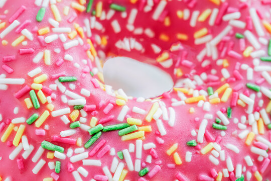 Donut with colorful sprinkles close-up. Food Background