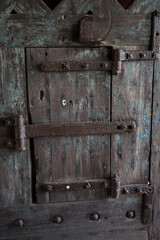 Old wooden door with metal hinges 