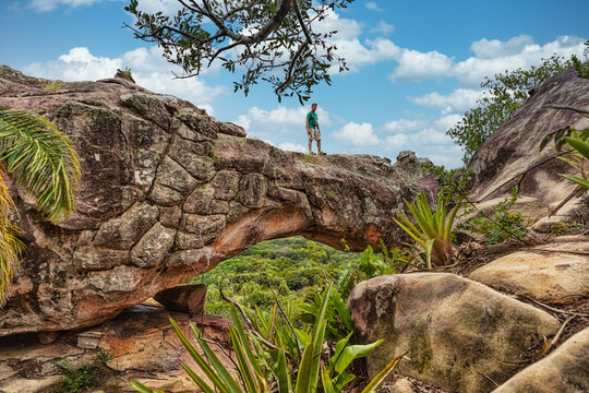 A man on the rock arch on Cerro Arco in Tobati in Paraguay.