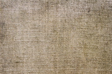 Background, texture of beige fabric, woven burlap close-up. Photography, abstraction.