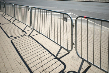 Portable sectional fence. Steel mobile fence on the street. Police fence.