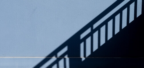 Stairway Shadow on a Dark Gray Wall Background.