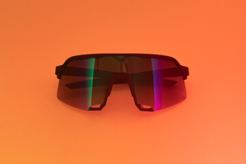 Studio shot of isolated sports sunglasses on orange background