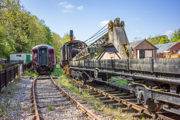 old and abandoned railway carriages and rail industry equipment in a disused railway yard