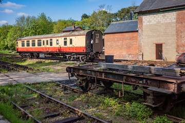 old and abandoned railway carriages and rail industry equipment in a disused railway yard