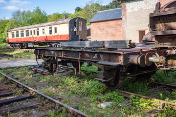 Fototapeta na wymiar old and abandoned railway carriages and rail industry equipment in a disused railway yard