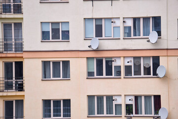 Obraz premium Architectural details of modern high apartment building facade with many windows and balconies