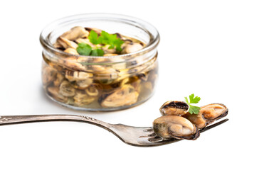 Marinated mussels on fork isolated on white