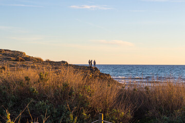 Boys watching the Mediterranean sea at the coast