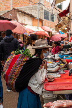 Peruvian woman shopping in the urban market. Food in the market.
