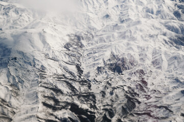 Aerial view of snowy mountains with clouds