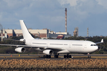 Large four engined commercial airliner airplane on the runway waiting for takeoff.