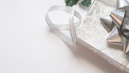 silver gift box and silver ribbon on white background