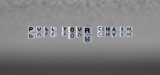 pull your chain word or concept represented by black and white letter cubes on a grey horizon...