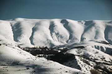 Fototapeta na wymiar Landscape of mountains with snow and blue sky