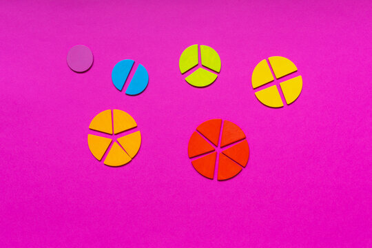 Multicolored fractions, rulers, pencils on a magenta pink background. Interesting, fun math for kids. Education, back to school concept