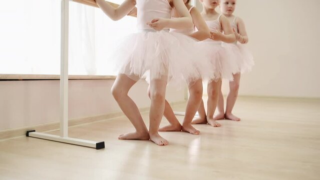 Spine must be straight. Team of little ballerinas have practice session indoors