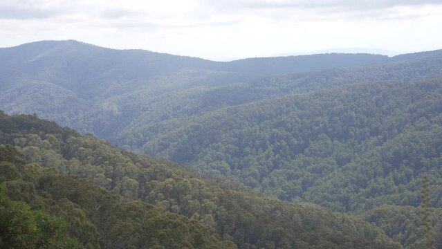 Rolling Victorian high country in foreground and background, with clouds floating above in Mt Buller