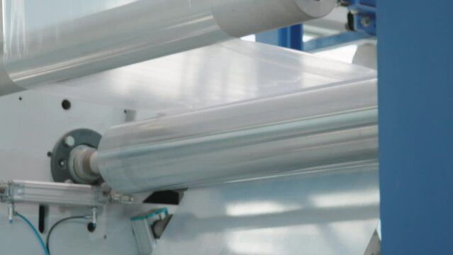Plastic film manufacturing production line for packaging. Multilayer blown film extrusion machine. Plastics and chemical industry themes.