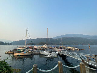 Sailboats at a marina with mountains in the background and blue skies, Egmont, northern British...