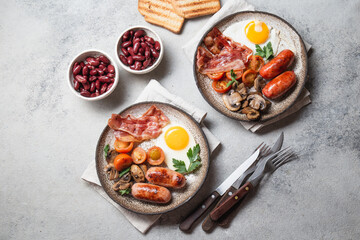 Fototapeta na wymiar English breakfast on gray plates on white background
