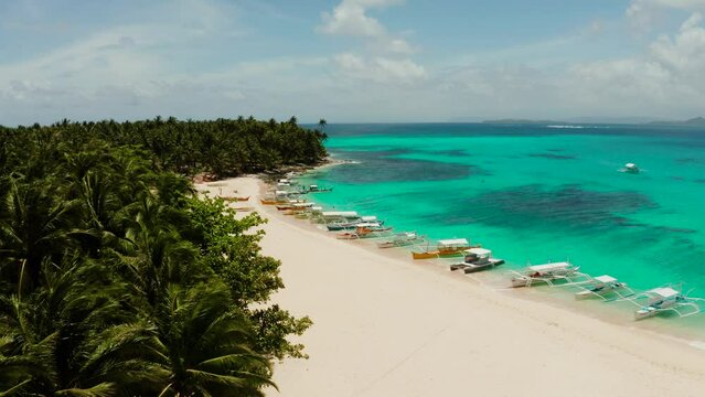 Sand beach and tropical islands, palm trees by atoll with coral reef, top view. Daco island, Philippines. Summer and travel vacation concept