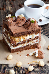 a piece of cake made of chocolate sponge cake cream and caramel with hazelnuts