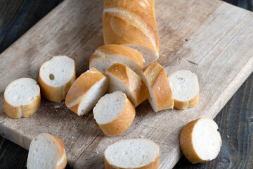 wheat baguette cut into pieces on a cutting board