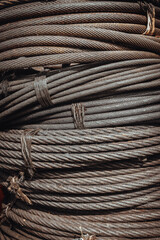 Coil large Wire rope sling or Cable sling drum reels stocked in store. Steel wire cable or rope for heavy industrial use, Wire rope texture, Selective Focus.