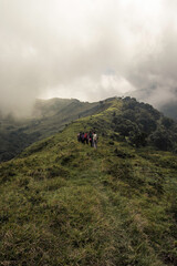 Obraz premium vertical shot of a group of hikers on a hill in the green mountains of Costa Rica