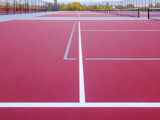 Red tennis court with gray pickleball lines