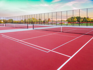 Red tennis court with gray pickleball lines