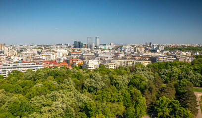 Fototapeta na wymiar Bucharest from above, aerial view over Herastrau (King Michael I) Park, lake and the north part of the city with office building photographed during a summer sunny day.