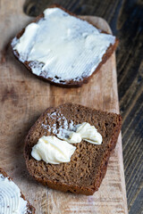 slices of black sliced bread with butter spread from milk
